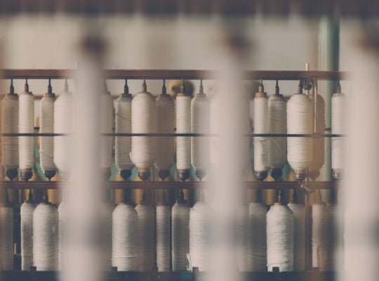 photography of white treadle on brown wooden rack