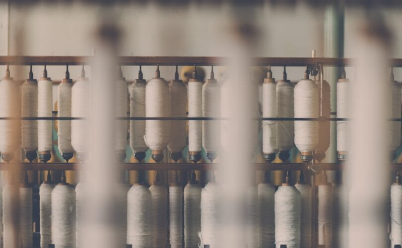 photography of white treadle on brown wooden rack